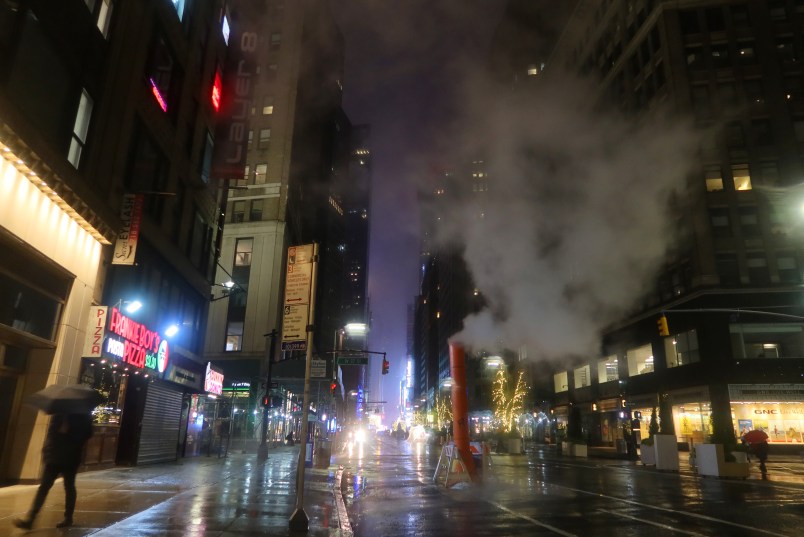 NEW YORK , NY - DEC 11: People walk along Broadway in the rain before sunrise on December 11, 2019, in New York City. (Photo by Gary Hershorn/Getty Images)