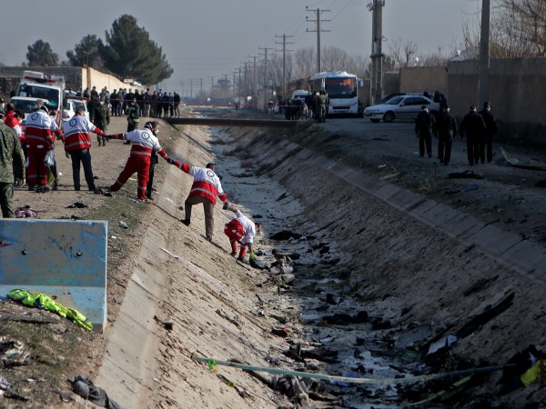 TEHRAN, Jan. 8, 2020 -- Rescuers work at the air crash site of a Boeing 737 Ukrainian passenger plane in Parand district, southern Tehran, Iran, on Jan. 8, 2020. All the passengers and crew members on board the Boeing 737 Ukrainian passenger plane that crashed near Tehran Imam Khomeini International Airport on Wednesday morning are confirmed dead, official Islamic Republic News Agency reported. (Photo by Ahmad Halabisaz/Xinhua via Getty)