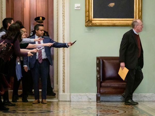 WASHINGTON, DC - JANUARY 30: Reporters reach out with their cell phones and audio recorders trying to get a statement from Sen. Lamar Alexander (R-TN) as he passes by during a recess in the Senate impeachment trial of President Donald Trump on January 30, 2020 in Washington, DC. The trial has entered into the second day of the question phase where Senators have the opportunity to submit written questions to the House managers and President Trump's defense team. (Photo by Samuel Corum/Getty Images) *** Local Caption *** Lamar Alexander