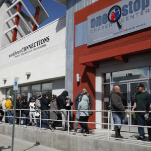 People wait in line for help with unemployment benefits at the One-Stop Career Center, Tuesday, March 17, 2020, in Las Vegas. Nevada Department of Employment, Training and Rehabilitation and it’s partner organizations, like the One-Stop Career Center, have seen an increase in traffic due to the coronavirus. (AP Photo/John Locher)