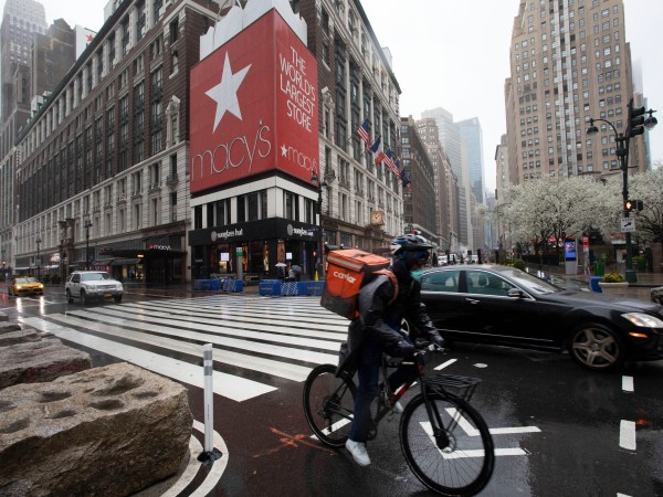 A cyclist passes Macy’s in Herald Square, Monday, March 23, 2020 in New York. Macy’s stores nationwide are closed due to the coronavirus. (AP Photo/Mark Lennihan)