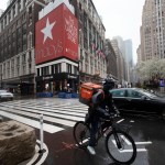 A cyclist passes Macy’s in Herald Square, Monday, March 23, 2020 in New York. Macy’s stores nationwide are closed due to the coronavirus. (AP Photo/Mark Lennihan)