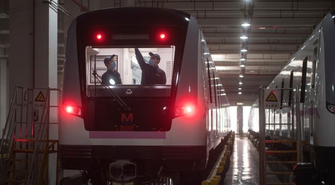 In this March 23, 2020 photo released by Xinhua News Agency, workers prepares a subway train for restoration of public transport in Wuhan, in central China's Hubei province. China's health ministry says Wuhan has now gone several consecutive days without a new infection, showing the effectiveness of draconian travel restrictions that are slowly being relaxed around the country.  (Xiao Yijiu/Xinhua via AP)