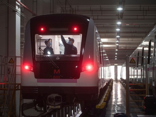 In this March 23, 2020 photo released by Xinhua News Agency, workers prepares a subway train for restoration of public transport in Wuhan, in central China's Hubei province. China's health ministry says Wuhan has now gone several consecutive days without a new infection, showing the effectiveness of draconian travel restrictions that are slowly being relaxed around the country.  (Xiao Yijiu/Xinhua via AP)