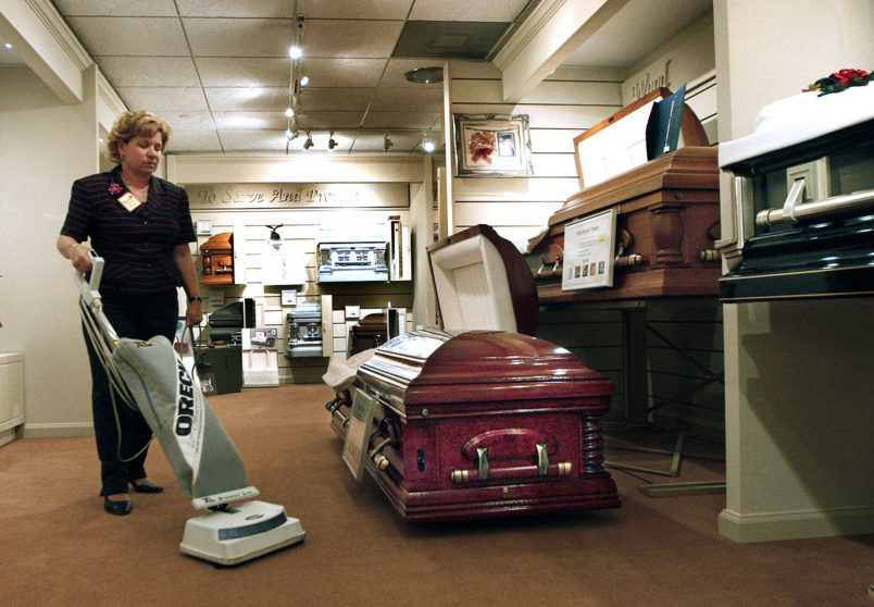 Patricia Jo Ralph, funeral director at T.M. Ralph Funeral Homes in Plantation, Florida, vacuums around a casket, April 3, 2009. The funeral industry is suffering in the recession as people choose cheaper services or cremation. Some funeral homes are cutting costs by doing things themselves. (Lilly Echeverria/Miami Herald/MCT)