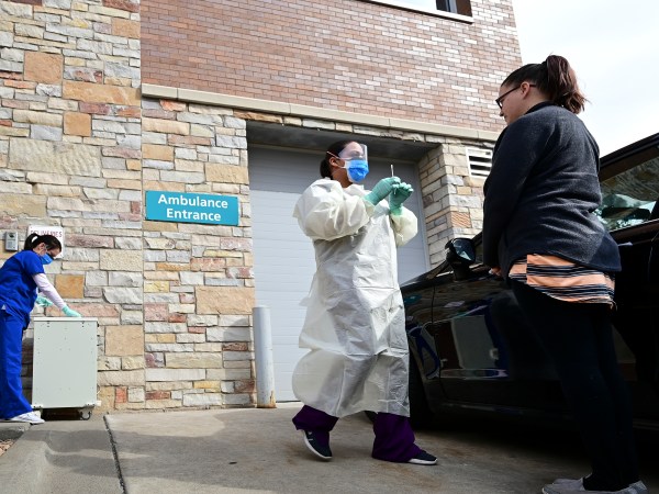 Fridley, MN March 10: M Health Fairview Medical Assistants Reece Wallaker, center, and Sandy Graves, administered a COVID-19 test to an actor and fellow Fairview employee, Nichole Brown, outside the M Health Fairview Fridley clinic Tuesday. (Photo by Aaron Lavinsky/Star Tribune via Getty Images)