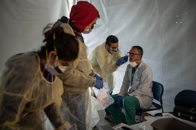 NEW YORK, NY - MARCH 24:  Doctors test hospital staff with flu-like symptoms for COVID-19. St. Barnabas hospital in the Bronx set-up tents to triage possible COVID-19 patients outside before they enter the main Emergency department area on March 24, 2020 in New York City. (Photo by Misha Friedman/Getty Images)
