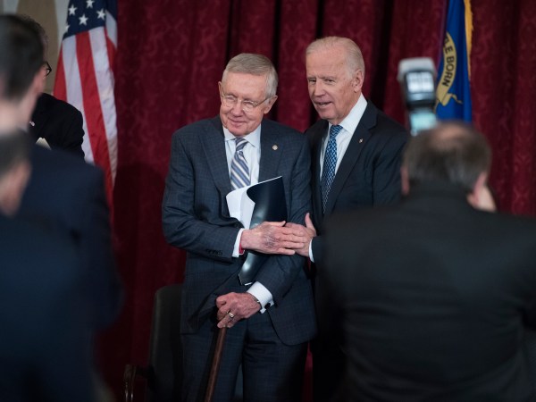 UNITED STATES - DECEMBER 08: Vice President Joe Biden, right, greets retiring Senate Minority Leader Harry Reid, D-Nev., during a portrait unveiling ceremony for Reid in Russell Building's Kennedy Caucus Room, December 08, 2016. (Photo By Tom Williams/CQ Roll Call)