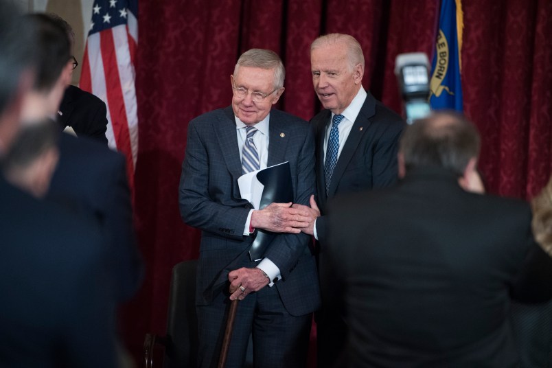 UNITED STATES - DECEMBER 08: Vice President Joe Biden, right, greets retiring Senate Minority Leader Harry Reid, D-Nev., during a portrait unveiling ceremony for Reid in Russell Building's Kennedy Caucus Room, December 08, 2016. (Photo By Tom Williams/CQ Roll Call)