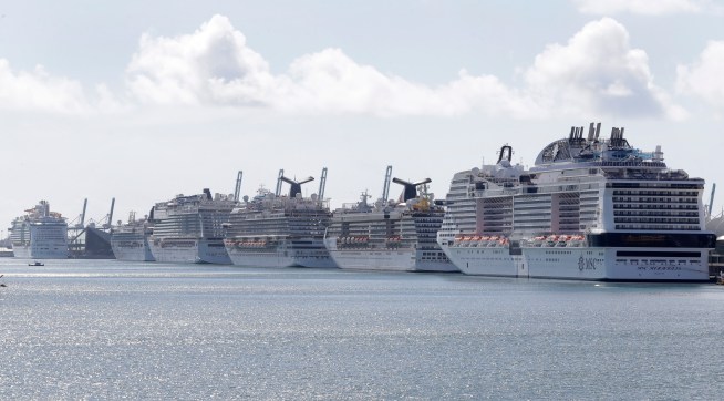 Cruise ships are shown docked at PortMiami, Tuesday, March 31, 2020, in Miami. (AP Photo/Wilfredo Lee)