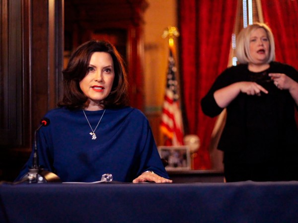 In a pool photo provided by the Michigan Office of the Governor, Gov. Gretchen Whitmer addresses the state during a speech in Lansing, Mich., Monday, March 30, 2020. The governor said she suspended state hiring and promotions and vetoed $80 million in new spending in order to steer money to fighting the coronavirus. At the same time, Whitmer said she signed laws with $150 million for the state's response. She said it's too early to know how the economic slowdown related to the virus will affect state revenue but the impact "is going to be real.” (Michigan Office of the Governor via AP, Pool)