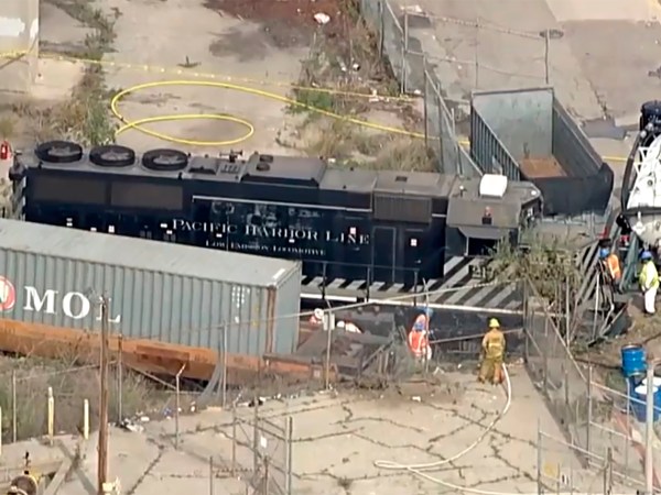 This image taken from video provided by KABC-TV shows a Pacific Harbor Line train that derailed Tuesday, March 31, 2020, at the  Port of Los Angeles after running through the end of the track and crashing through barriers, finally coming to rest about 250 yards from the docked naval ship. The train engineer intentionally drove the speeding locomotive off a track at the Port of Los Angeles because he was suspicious about the presence of a Navy hospital ship docked there amid the coronovirus crisis. (KABC-TV via AP)
