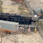 This image taken from video provided by KABC-TV shows a Pacific Harbor Line train that derailed Tuesday, March 31, 2020, at the  Port of Los Angeles after running through the end of the track and crashing through barriers, finally coming to rest about 250 yards from the docked naval ship. The train engineer intentionally drove the speeding locomotive off a track at the Port of Los Angeles because he was suspicious about the presence of a Navy hospital ship docked there amid the coronovirus crisis. (KABC-TV via AP)