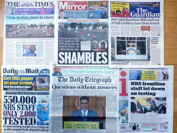 Front Pages of Britain's newspapers showing their coverage of the coronavirus, are displayed in London, Thursday, April 2, 2020. Newspapers in Britain have criticised the lack of testing NHS staff for the virus. The new coronavirus causes mild or moderate symptoms for most people, but for some, especially older adults and people with existing health problems, it can cause more severe illness or death. (AP Photo/Kirsty Wigglesworth)