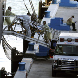 A person on a stretcher is removed from Carnaval’s Holland America cruise ship Zaandam at Port Everglades during the new coronavirus pandemic, Thursday, April 2, 2020, in Fort Lauderdale, Fla. Those passengers that are fit for travel in accordance with guidelines from the U.S. Centers for Disease Control will be permitted to disembark. (AP Photo/Lynne Sladky)