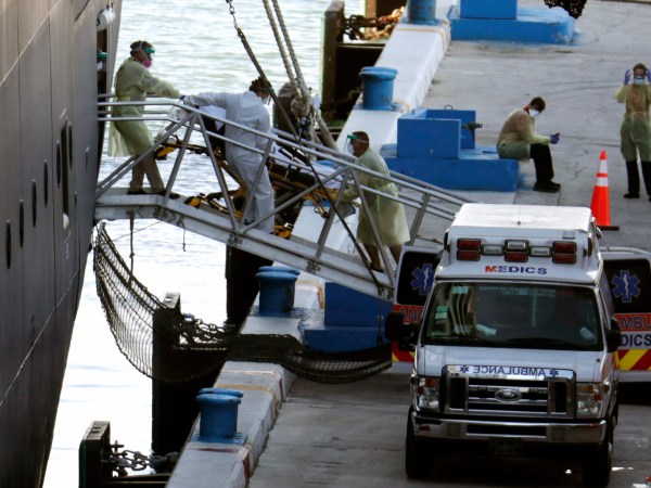 A person on a stretcher is removed from Carnaval’s Holland America cruise ship Zaandam at Port Everglades during the new coronavirus pandemic, Thursday, April 2, 2020, in Fort Lauderdale, Fla. Those passengers that are fit for travel in accordance with guidelines from the U.S. Centers for Disease Control will be permitted to disembark. (AP Photo/Lynne Sladky)