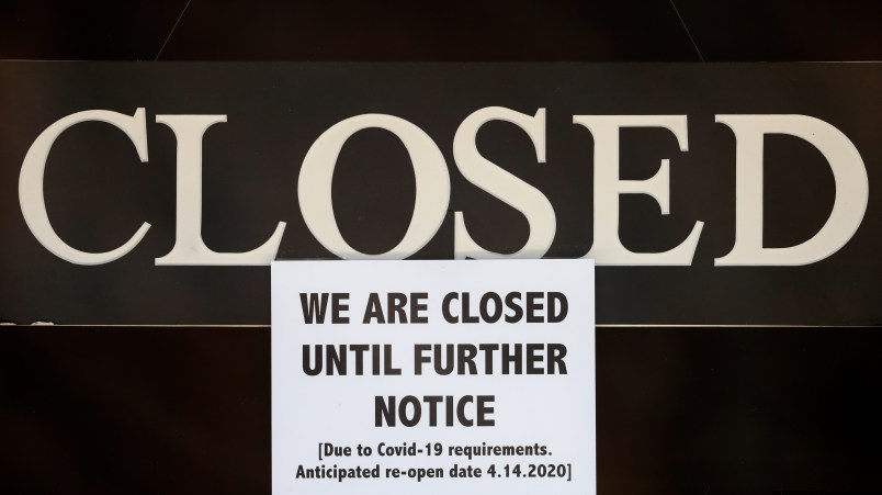 A notice of closure is posted at The Great Frame Up in Grosse Pointe Woods, Mich., Thursday, April 2, 2020. The coronavirus COVID-19 outbreak has triggered a stunning collapse in the U.S. workforce with 10 million people losing their jobs in the past two weeks and economists warn unemployment could reach levels not seen since the Depression, as the economic damage from the crisis piles up around the world. (AP Photo/Paul Sancya)