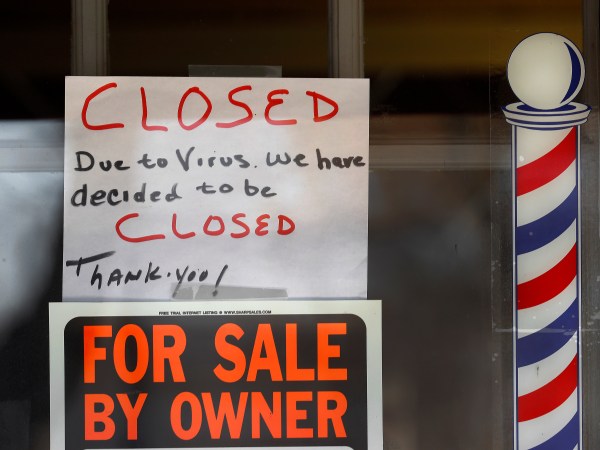 A For Sale By Owner and closed due virus sign are shown at Images On Mack in Grosse Pointe Woods, Mich., Thursday, April 2, 2020. The coronavirus COVID-19 outbreak has triggered a stunning collapse in the U.S. workforce with 10 million people losing their jobs in the past two weeks and economists warn unemployment could reach levels not seen since the Depression, as the economic damage from the crisis piles up around the world. (AP Photo/Paul Sancya)