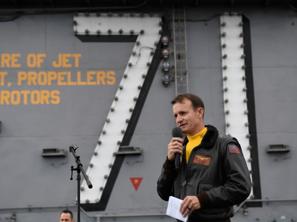 191115-N-IW125-1033 PACIFIC OCEAN (Nov. 14, 2019) Capt. Brett Crozier, commanding officer of the aircraft carrier USS Theodore Roosevelt (CVN 71), addresses the crew during an all-hands call on the ship’s flight deck. Theodore Roosevelt is conducting routine operations in the Eastern Pacific Ocean. (U.S. Navy photo by Mass Communication Specialist 3rd Class Nicholas Huynh)