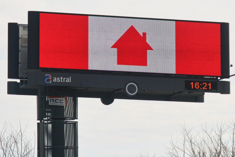 Sign with a Canadian flag (the maple leaf has been replaced with the symbol of a house) urging Canadians to stay at home to slow the spread of the novel coronavirus (COVID-19)in Vaughan, Ontario, Canada on April 12, 2020. The Ontario provincial government extended the state of emergency until April 23 due to the COVID-19 outbreak on Saturday. (Photo by Creative Touch Imaging Ltd./NurPhoto)
