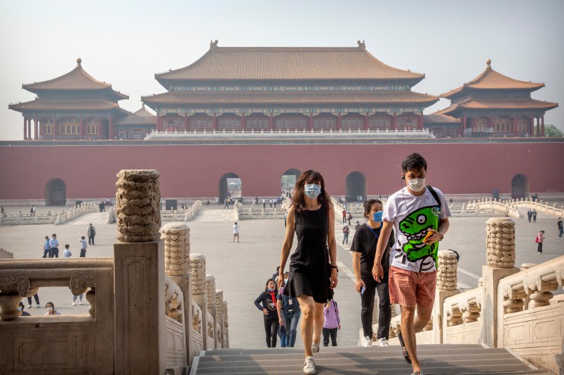 Visitors wearing face masks to protect against the new coronavirus walk through the Forbidden City in Beijing, Friday, May 1, 2020. The Forbidden City reopened beginning on Friday, China’s May Day holiday, to limited visitors after being closed to the public for more than three months during the coronavirus outbreak. (AP Photo/Mark Schiefelbein)