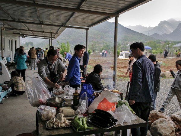 People gather for a barbecue at a scenic area in Fangshan district in Beijing, Monday, May 4, 2020, after authorities loosened up nationwide restrictions after months of lockdown over the coronavirus outbreak. China reported three new coronavirus cases Monday, all brought from overseas, and no additional deaths. (AP Photo/Andy Wong)