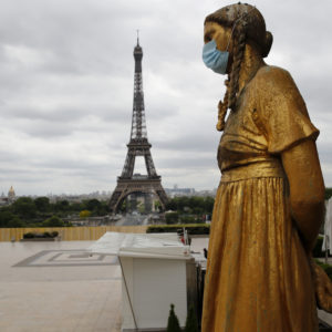 A statue wears a mask along Trocadero square close to the Eiffel Tower in Paris, Monday, May 4, 2020. France continues to be under an extended stay-at-home order until May 11 in an attempt to slow the spread of the COVID-19 pandemic. (AP Photo/Christophe Ena)
