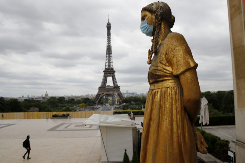 A statue wears a mask along Trocadero square close to the Eiffel Tower in Paris, Monday, May 4, 2020. France continues to be under an extended stay-at-home order until May 11 in an attempt to slow the spread of the COVID-19 pandemic. (AP Photo/Christophe Ena)