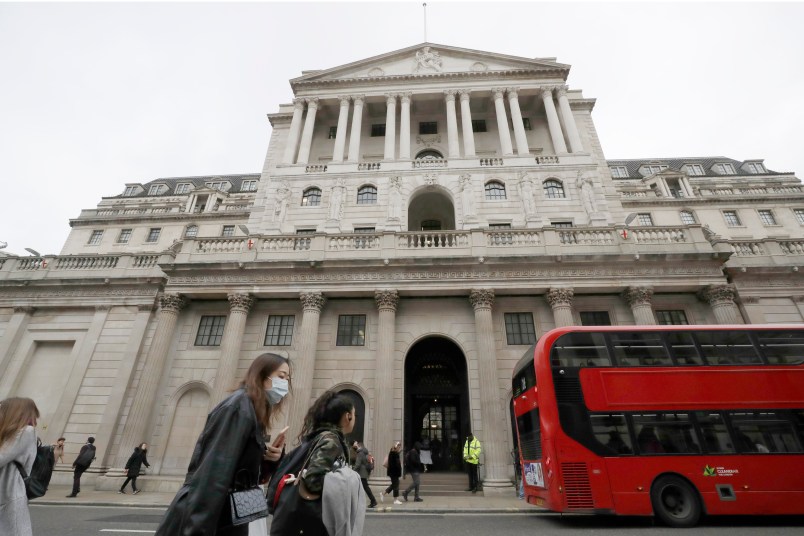 Pedestrians wearing face masks walk past the Bank of England in London, Wednesday, March 11, 2020. Britain's Chancellor of the Exchequer Rishi Sunak will announce the first budget since Britain left the European Union. (AP Photo/Matt Dunham)