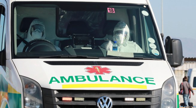 In this photo taken Tuesday, May 19, 2020, paramedics in protective gear drive in an ambulance in Khayelitsha in Cape Town South Africa,  With dramatically increased community transmission, Cape Town has become the center of the COVID-19 outbreak in South Africa and the entire continent. (AP Photo/Nardus Engelbrecht)