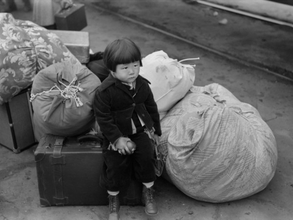 Japanese-American Child Waiting for Train to Owens Valley During Evacuation of Japanese-Americans from West Coast Areas under U.S. Army War Emergency Order, Los Angeles, California, USA, Russell Lee, Office of War Information, April 1942