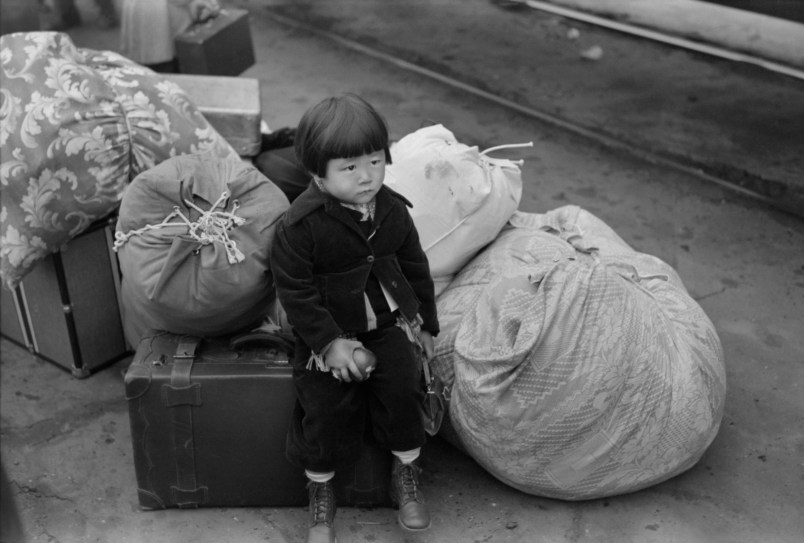 Japanese-American Child Waiting for Train to Owens Valley During Evacuation of Japanese-Americans from West Coast Areas under U.S. Army War Emergency Order, Los Angeles, California, USA, Russell Lee, Office of War Information, April 1942