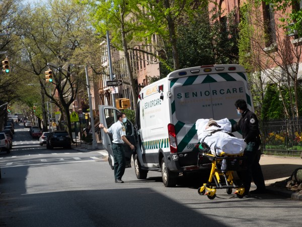 NEW YORK, UNITED STATES - APRIL 24, 2020: Two medical workers transport an elderly man from the Cobble Hill nursing home in Brooklyn to a nearby hospital amid the coronavirus crisis.As the US surpasses 50,000 confirmed coronavirus deaths, New York State’s antibody tests suggest that 14.9% of new yorkers are positive for Covid-19.