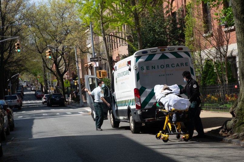 NEW YORK, UNITED STATES - APRIL 24, 2020: Two medical workers transport an elderly man from the Cobble Hill nursing home in Brooklyn to a nearby hospital amid the coronavirus crisis.As the US surpasses 50,000 confirmed coronavirus deaths, New York State’s antibody tests suggest that 14.9% of new yorkers are positive for Covid-19.