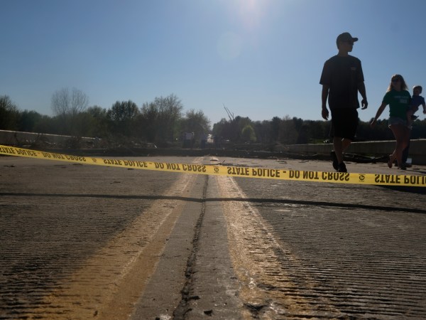 Edenville, MI - MAY 20: Edenville residents explore what remains of the West Curtis Road  bridge which was swept away following extreme flooding throughout central Michigan on May 20, 2020. Tuesday night into Wednesday morning saw record flooding as two dams in Sanford and Eden were breached. (Photo by Matthew Hatcher/Getty Images)