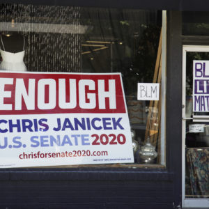 An election sign for Democratic Senate candidate Chris Janicek is seen in Omaha, Neb., Tuesday, June 16, 2020. The Nebraska Democratic Party is calling on its U.S. Senate nominee to drop out of the race after he made sexually repugnant comments about a campaign staffer in a group text with her and other staffers. The party says its state executive committee voted unanimously on Monday to withdraw all of its resources from Chris Janicek’s campaign. (AP Photo/Nati Harnik)