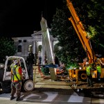 Workers remove a Confederate monument with a crane on Thursday, June 18, 2020, in Decatur, Georgia. The 30-foot obelisk in Decatur Square, erected by the United Daughters of the Confederacy in 1908, was order to be removed by a judge and placed in storage indefinitely. (AP Photo/Ron Harris)