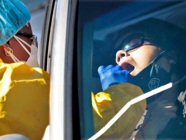 People get tested for COVID-19 at a drive through testing site hosted by the Puente Movement migrant justice organization Saturday, June 20, 2020, in Phoenix. Latinos are especially vulnerable to infection because they tend to live in tight quarters with multiple family members and have jobs that expose them to others. They also have a greater incidence of health conditions like diabetes that put them at higher risk for contracting COVID-19. (AP Photo/Matt York)