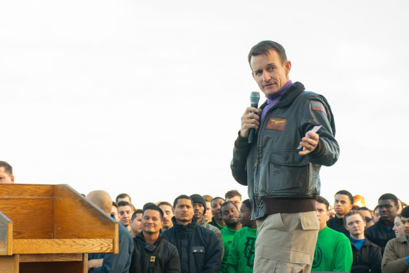 191215-N-KB540-3088 PACIFIC OCEAN (Dec. 19, 2019) Capt. Brett Crozier, commanding officer of the aircraft carrier USS Theodore Roosevelt (CVN 71), gives remarks during an all-hands call on the ship’s flight deck Dec. 15, 2019. Theodore Roosevelt is underway conducting routine training in the Eastern Pacific Ocean. (U.S. Navy photo by Mass Communication Specialist Seaman Alexander Williams)