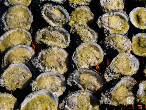 New Orleans, LA - April 30, 2020 - Charbroiled oysters are prepared in the parking lot of St. Dominic Church by staff from Drago's Seafood Restaurant.Many local restaurants have resorted to curbside service and orders to-go during the stay-at-home order to prevent the spread of the coronavirus. (William Widmer for The Washington Post)
