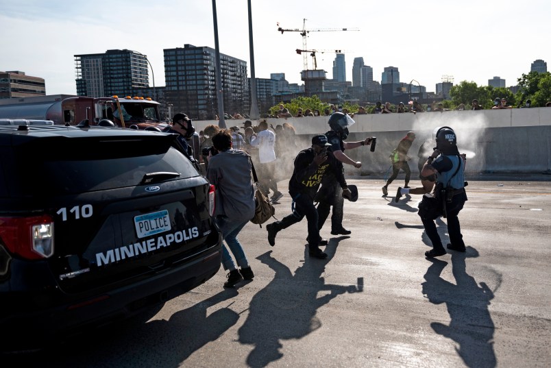 MINNEAPOLIS, MN - MAY 31: Police arrive and spray pepper spray after a tanker truck drove into a peaceful protest on the I-35W bridge over the Mississippi River on May 31, 2020 in Minneapolis, Minnesota. A large group of protesters had been marching over the bridge on both lanes before a truck was driven into the crowd. (Photo by Stephen Maturen/Getty Images)