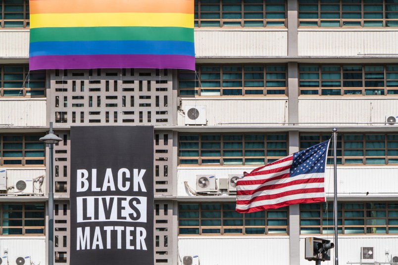 SEOUL, SOUTH KOREA - 2020/06/14: A Black Lives Matter banner, a United States national flag and a rainbow flag are hung on the facade of the US embassy building in Seoul.A Black Lives Matter (BLM) banner is hung on the facade of the US Embassy building in downtown Seoul in solidarity with the BLM protesters who are demanding for a positive change. (Photo by Simon Shin/SOPA Images/LightRocket via Getty Images)