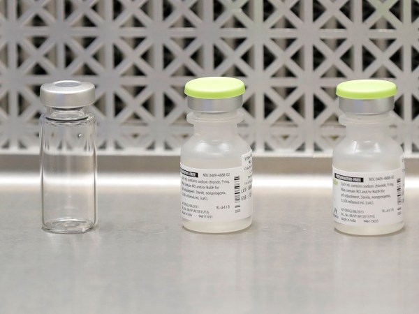 Vials used by pharmacists to prepare syringes used on the first day of a first-stage safety study clinical trial of the potential vaccine for COVID-19, the disease caused by the new coronavirus, rest on a lab table at the Kaiser Permanente Washington Health Research Institute in Seattle on Monday, March 16, 2020. (AP Photo/Ted S. Warren)