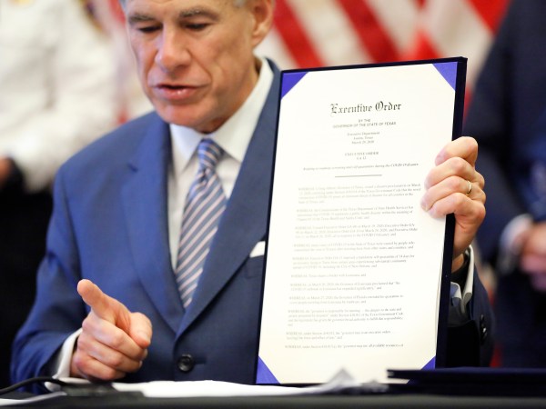 During a press conference at the Texas State Capitol in Austin, Texas Governor Greg Abbott holds a new executive order stating travel by road from any location in the state of Louisiana into Texas will require 14-day self quarantine, Sunday, March 29, 2020.  He also announced the US Army Corps of Engineers and the state are putting up a 250-bed field hospital at the Kay Bailey Hutchison Convention Center in downtown Dallas The space can expand to nearly 1,400 beds. (Tom Fox/The Dallas Morning News/Pool)