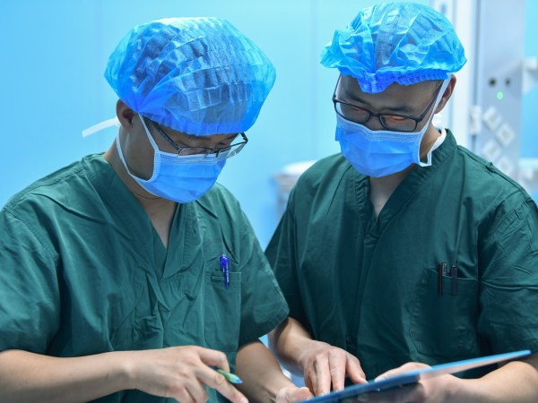 HOHHOT, May 12, 2020 -- Luo Mingchuan L works with his colleague at an operating room of the maternity and child healthcare hospital in Hohhot, north China's Inner Mongolia Autonomous Region, May 11, 2020. Luo Mingchuan, 28, is a nurse working at the maternity and child healthcare hospital of Inner Mongolia Autonomous Region. Amid the COVID-19 outbreak, Luo volunteered to go to central China's Hubei Province to aid the novel coronavirus control efforts there. At the Jianghan temporary hospital in Hubei, Luo has witnessed that patients' condition were improved both physically and mentally. Patients and medical workers have forged a strong relationship by fighting against the COVID-19 pandemic together. "It's great to see my patients get recovered and discharged from the hospital, and it's a touching moment when we waved goodbye," Luo said, "Working in Wuhan is an unforgettable experience, which has made me become more mature." (Photo by Wei Jingyu/Xinhua via Getty)