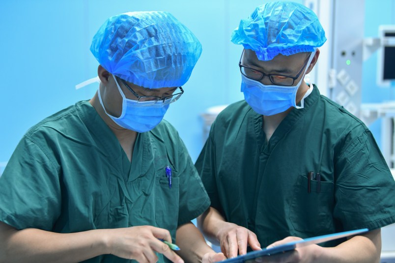 HOHHOT, May 12, 2020 -- Luo Mingchuan L works with his colleague at an operating room of the maternity and child healthcare hospital in Hohhot, north China's Inner Mongolia Autonomous Region, May 11, 2020. Luo Mingchuan, 28, is a nurse working at the maternity and child healthcare hospital of Inner Mongolia Autonomous Region. Amid the COVID-19 outbreak, Luo volunteered to go to central China's Hubei Province to aid the novel coronavirus control efforts there. At the Jianghan temporary hospital in Hubei, Luo has witnessed that patients' condition were improved both physically and mentally. Patients and medical workers have forged a strong relationship by fighting against the COVID-19 pandemic together. "It's great to see my patients get recovered and discharged from the hospital, and it's a touching moment when we waved goodbye," Luo said, "Working in Wuhan is an unforgettable experience, which has made me become more mature." (Photo by Wei Jingyu/Xinhua via Getty)