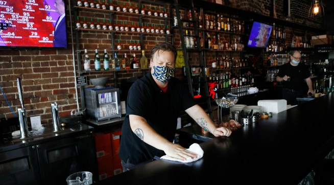TAMPA, FL - JUNE 26: Zack Vermes a bartender at  Carmine’s Ybor Italian restaurant wipes off the bar while awaiting patrons on June 26, 2020 in Tampa, Florida. Florida has suspended the consumption of alcohol at bars amid a surge in the positive coronavirus cases according to a tweet by Halsey Beshears, the secretary of the state Department of Business and Professional Regulation on Friday.  (Photo by Octavio Jones/Getty Images)