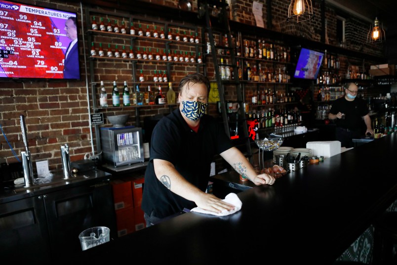 TAMPA, FL - JUNE 26: Zack Vermes a bartender at  Carmine’s Ybor Italian restaurant wipes off the bar while awaiting patrons on June 26, 2020 in Tampa, Florida. Florida has suspended the consumption of alcohol at bars amid a surge in the positive coronavirus cases according to a tweet by Halsey Beshears, the secretary of the state Department of Business and Professional Regulation on Friday.  (Photo by Octavio Jones/Getty Images)