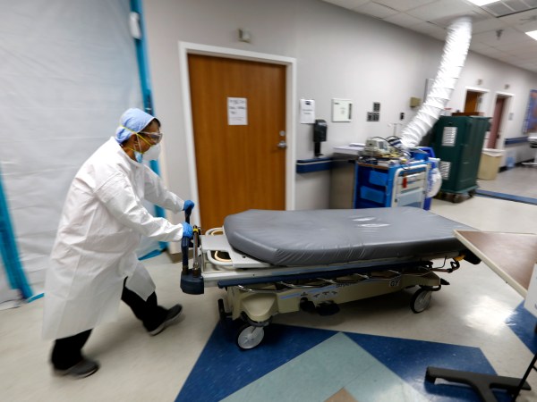 HOUSTON, TEXAS—JULY 1, 2020—An empty bed is moved back to the emergency room after brining in another COVID-19 patient. At United Memorial Medical Center in Houston, Texas, Dr. Joseph Varon leads a team to fight the increasing number of coronavirus patients in the expanded Covid-19 ward on July 1, 2020.  (Carolyn Cole/Los Angeles Times)