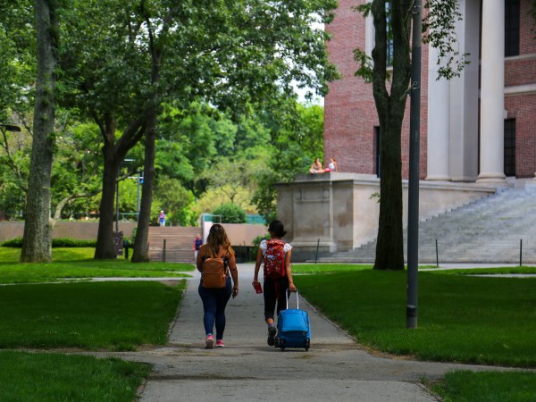 Two students are seen leaving their campus with baggage at Harvard University premises in Cambridge, MA, July 08, 2020. (Photo by Anik Rahman/NurPhoto)